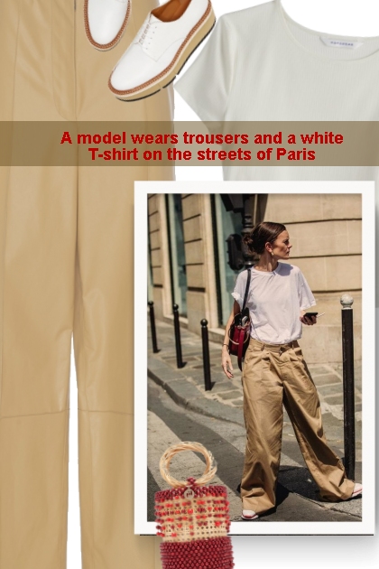 A model wears trousers and a white T-shirt on the 